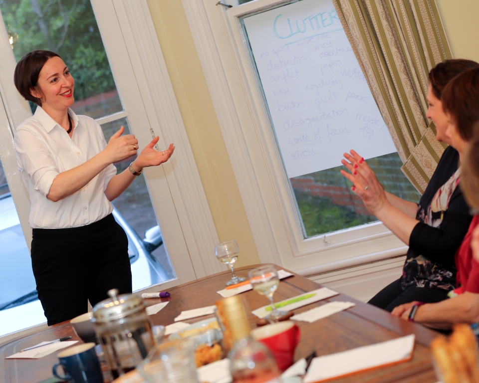 Ingrid Pope presenting to a group sitting around a board table